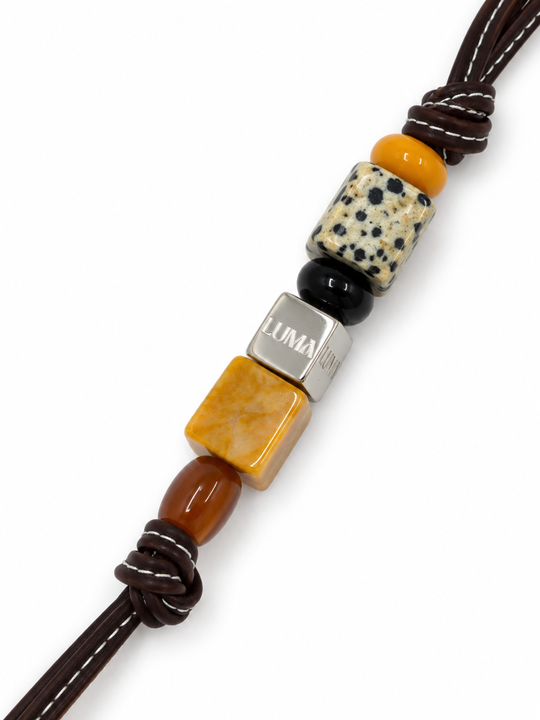 Savannah leather bag charm close-up with dalmatian jasper and LUMA cube