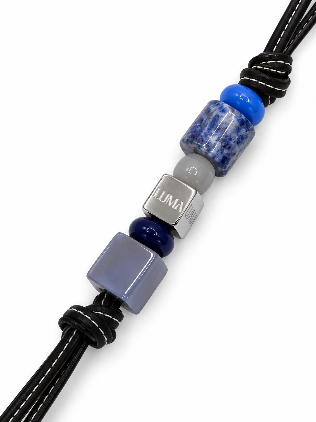 Tide leather bag charm close-up with blue stones and LUMA cube