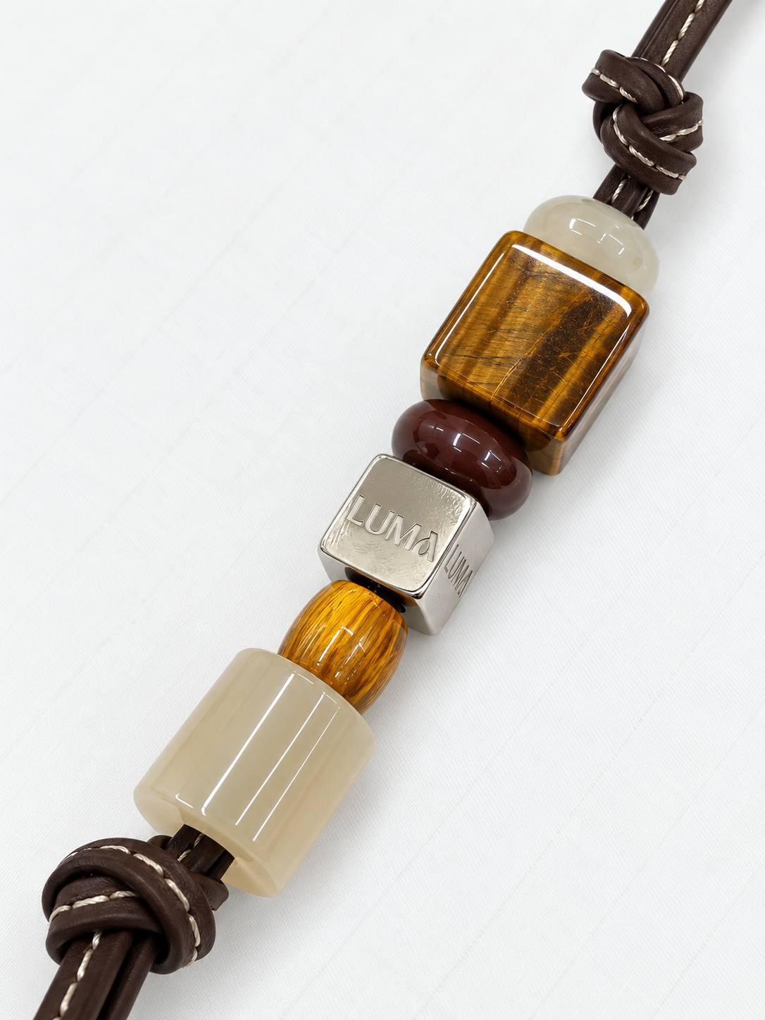 Wild Honey leather bag charm close-up with tiger's eye and LUMA cube